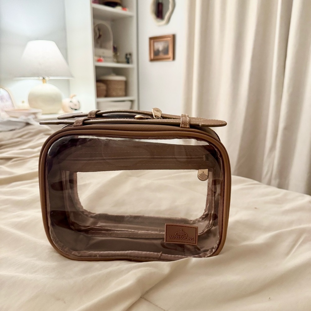 Impression Vanity Clear Travel Makeup Bag with brown Trim.